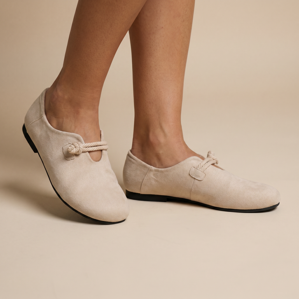 Beige loafers on feet