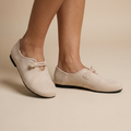 Beige loafers on feet