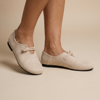 Beige loafers on feet