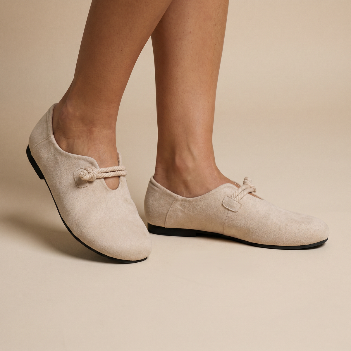 Beige loafers on feet
