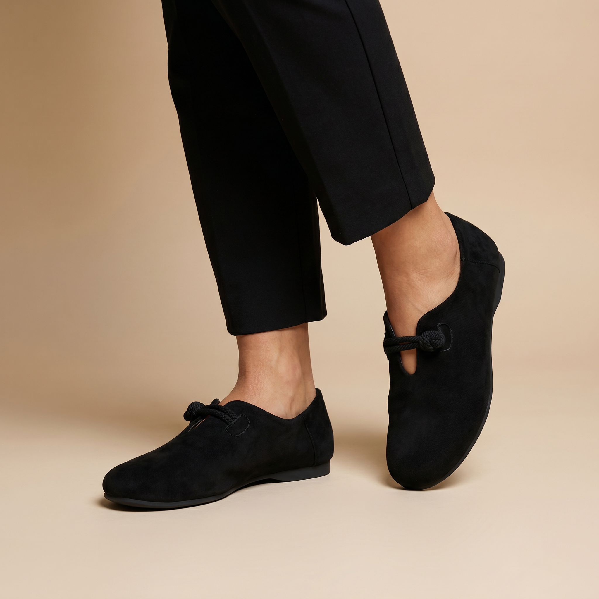 Black loafers on feet