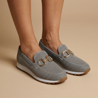 Grey loafers on feet